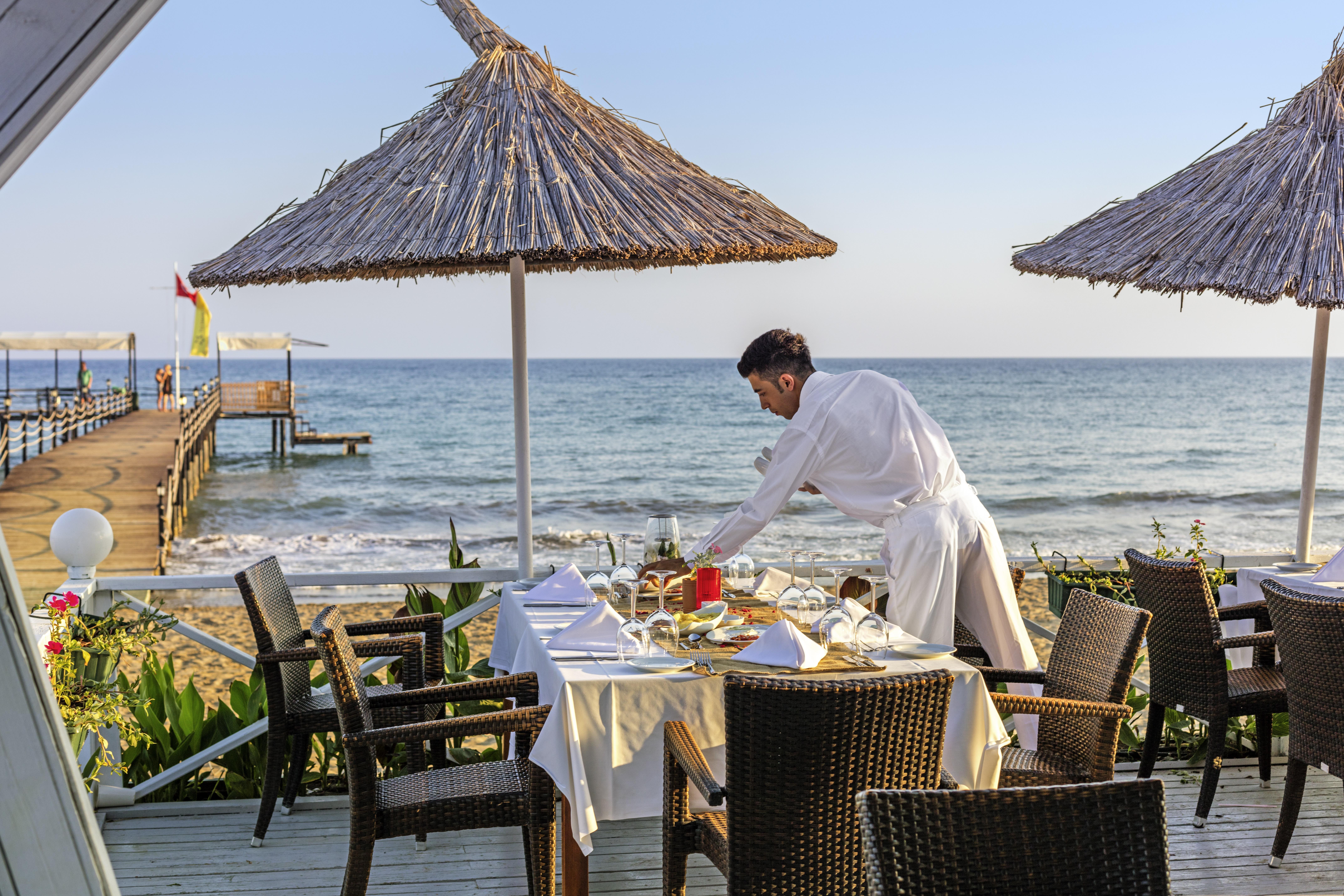 Asteria Family Resort Belek Antalya Exteriör bild A waiter at a beach restaurant